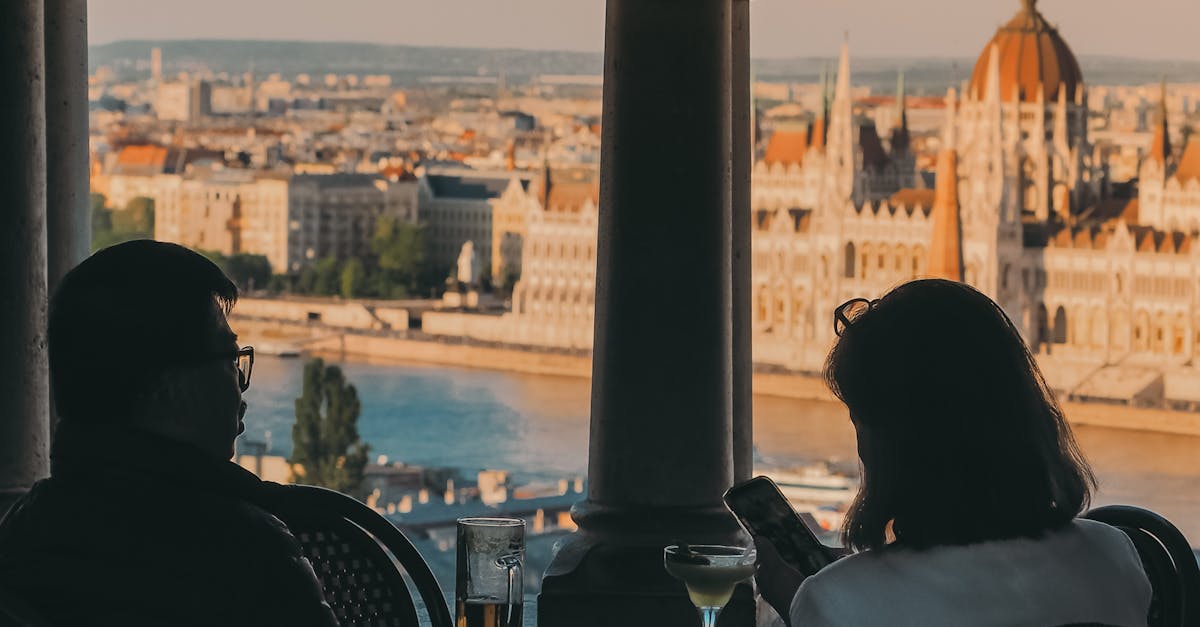 Panoramic view of Budapest at sunset with the Danube River, Chain Bridge, and Parliament Building illuminated in golden light