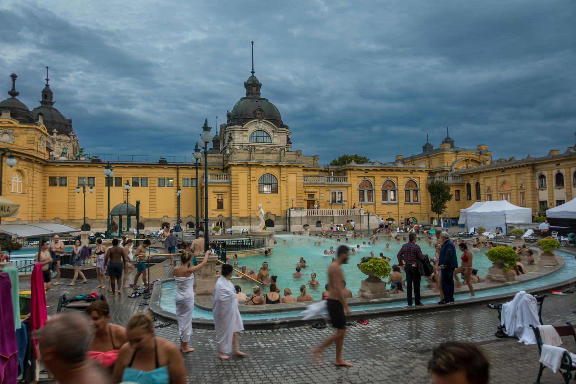 Visitors enjoying the outdoor pools at Széchenyi Thermal Bath in Budapest