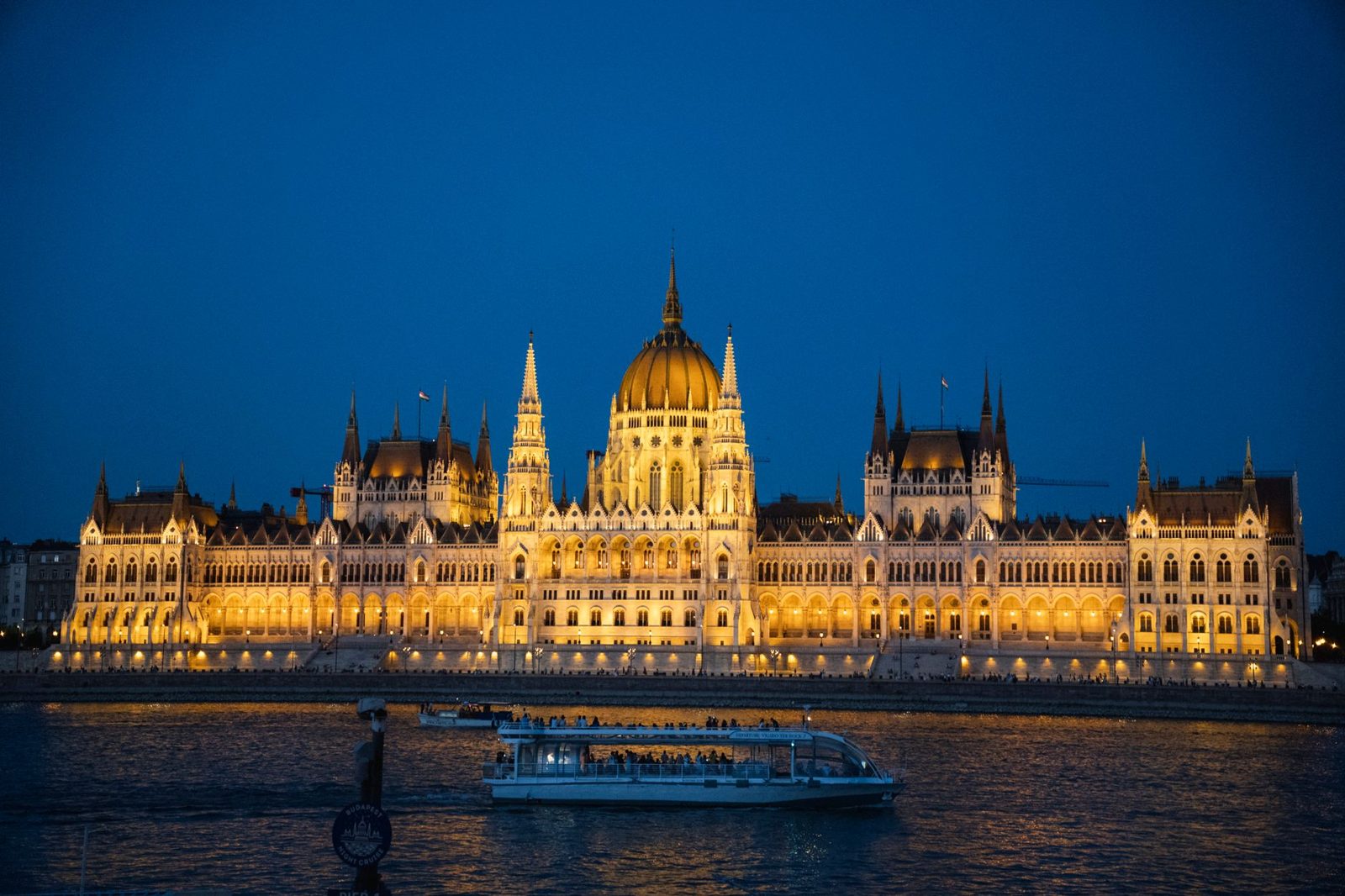 Budapest boat tour gliding past the floodlit Parliament at night