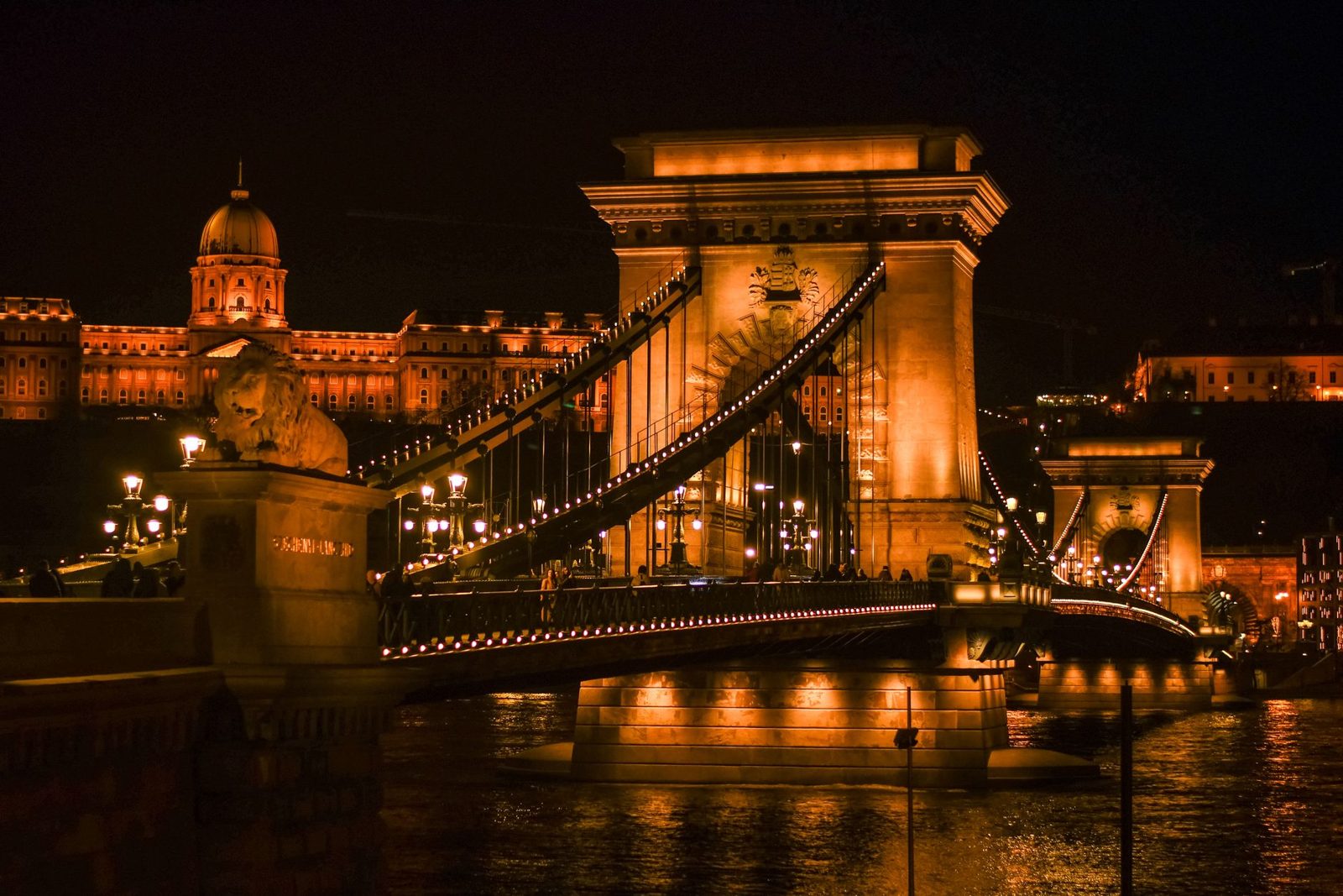 Chain Bridge lit up at night seen from a Budapest dinner cruise