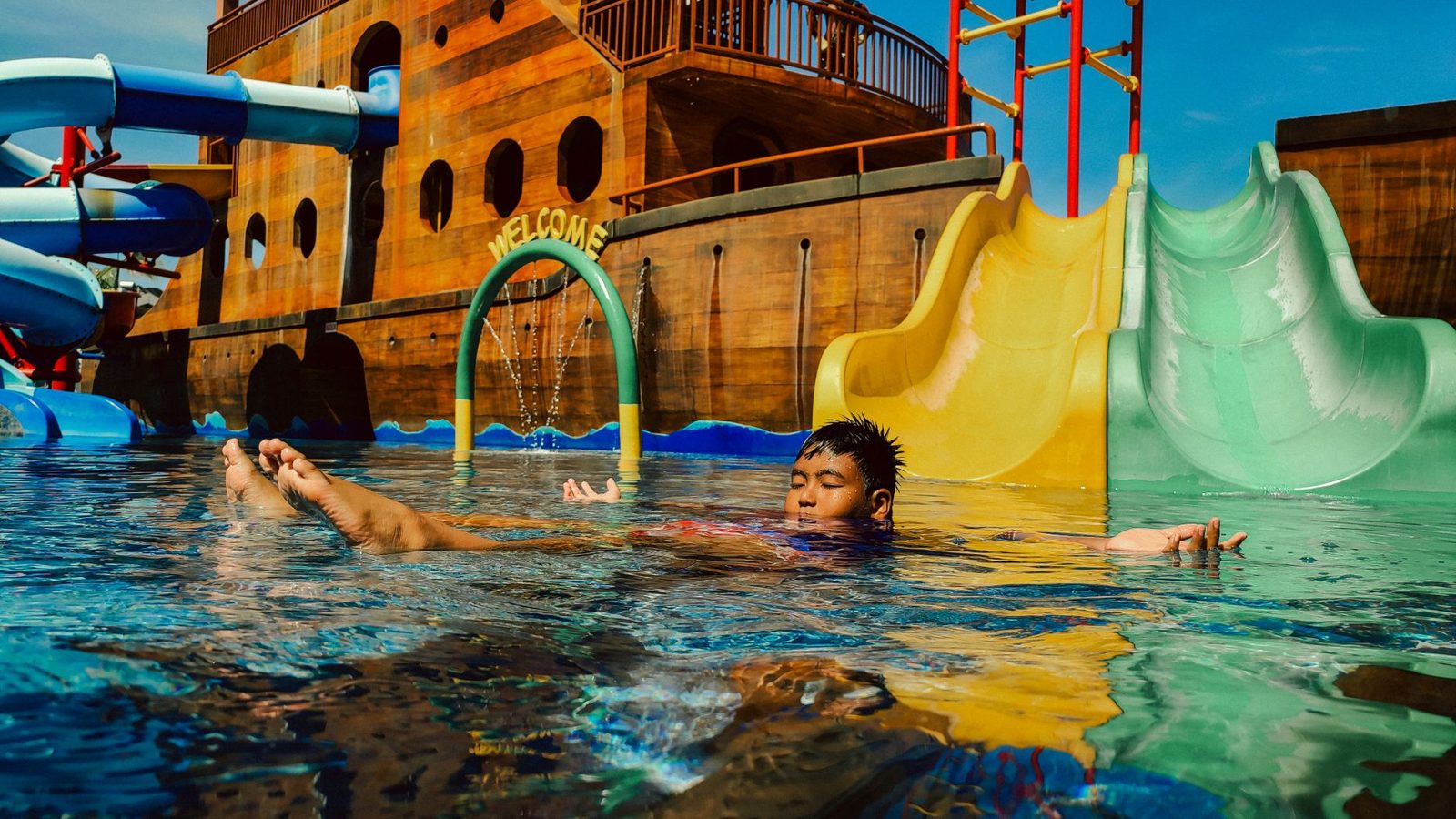 Children on a water slide at a family pool in Budapest