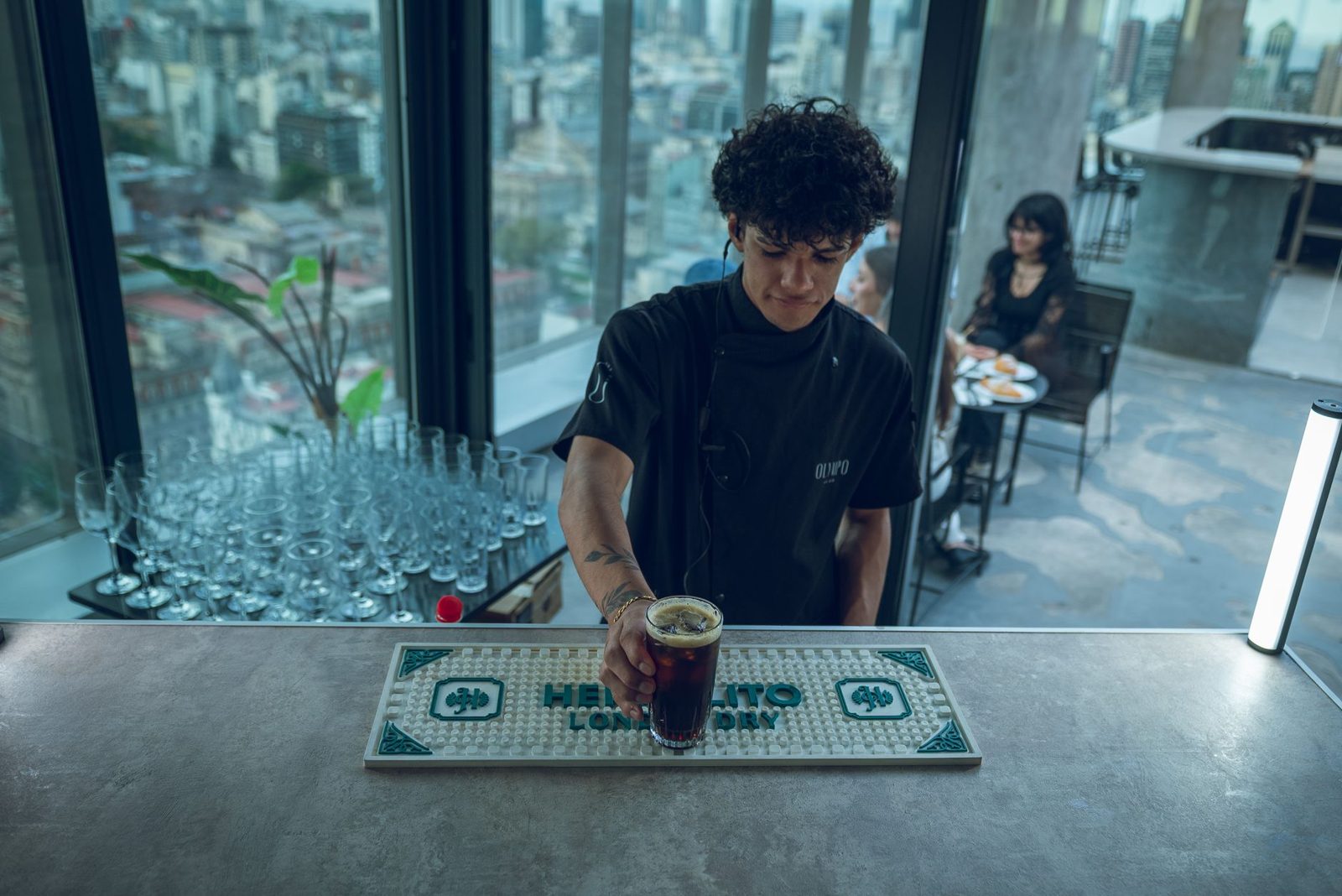Cocktails on a rooftop terrace overlooking the city