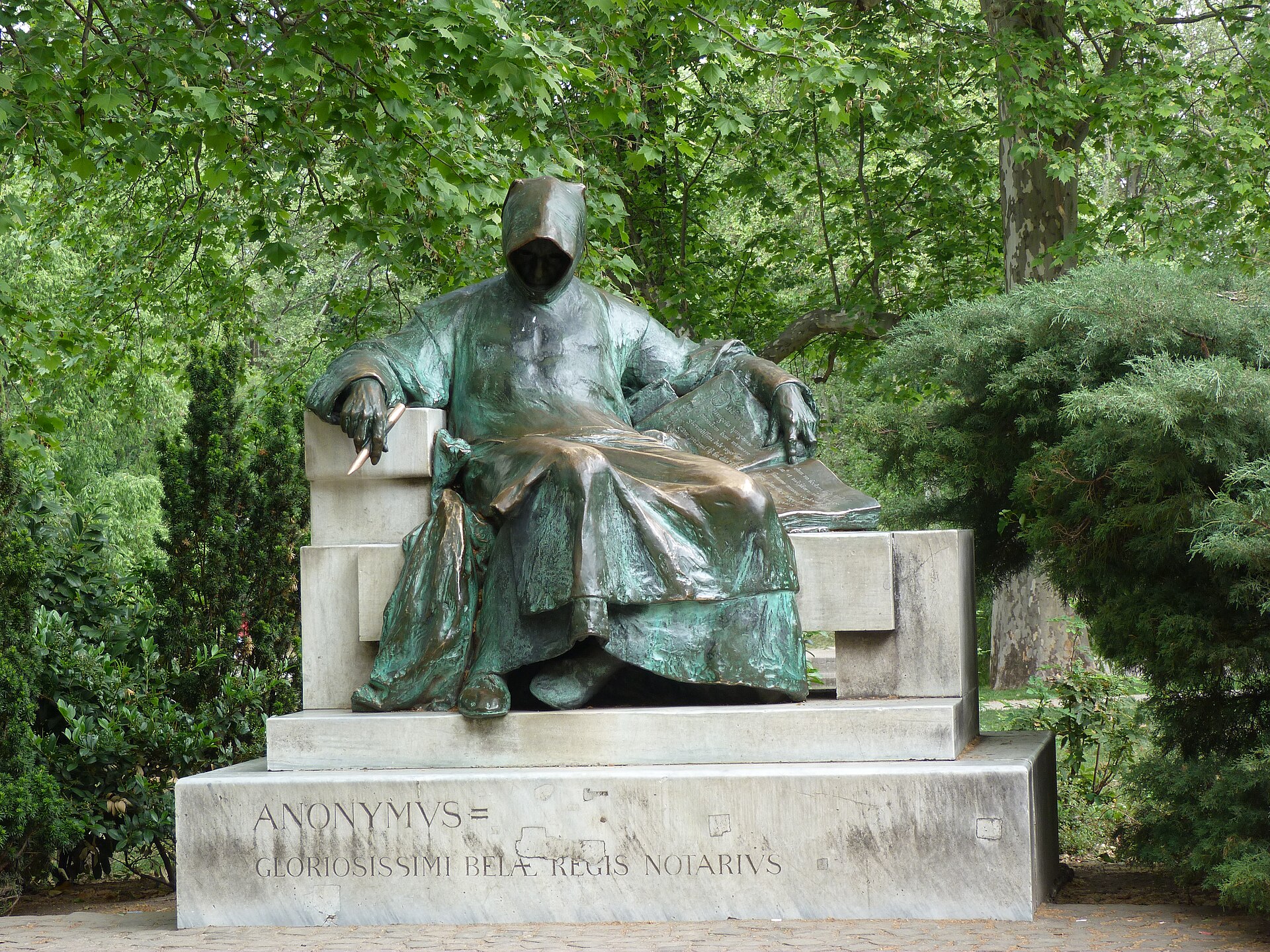 The bronze Anonymus statue at Vajdahunyad Castle in Budapest, a hooded figure holding a quill