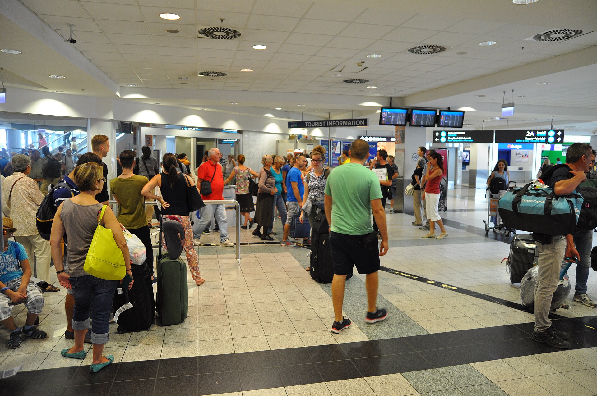 The arrivals hall at Budapest Airport, with Tourist Information and Terminal 2A signage