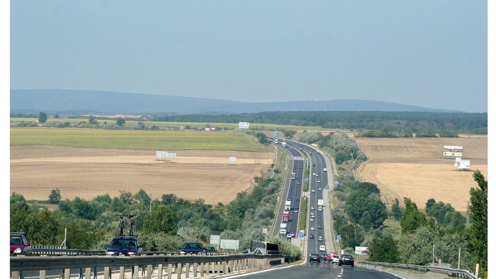 A Hungarian motorway heading toward the border, with cars and trucks in both directions