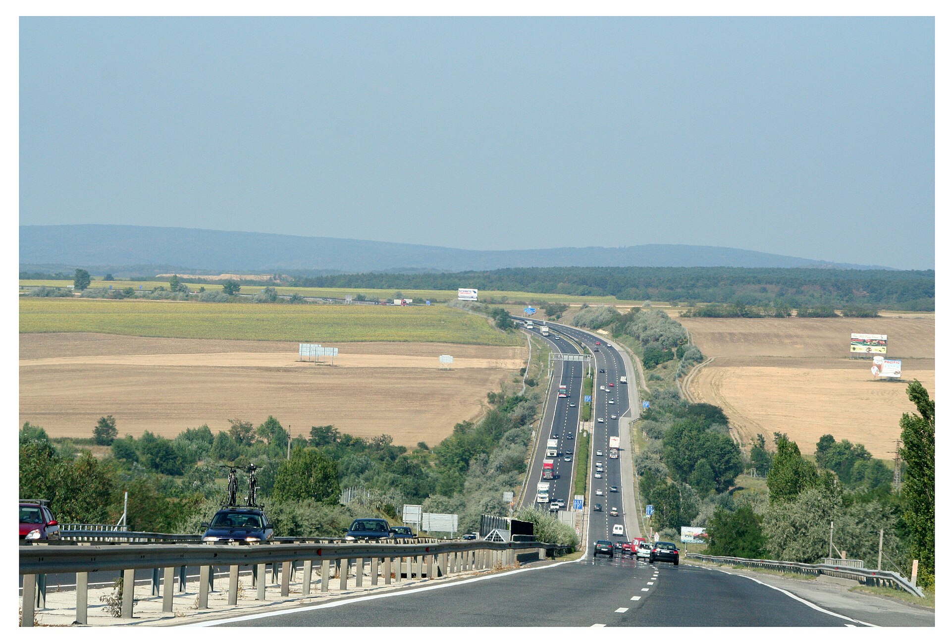 A Hungarian motorway heading toward the border, with cars and trucks in both directions