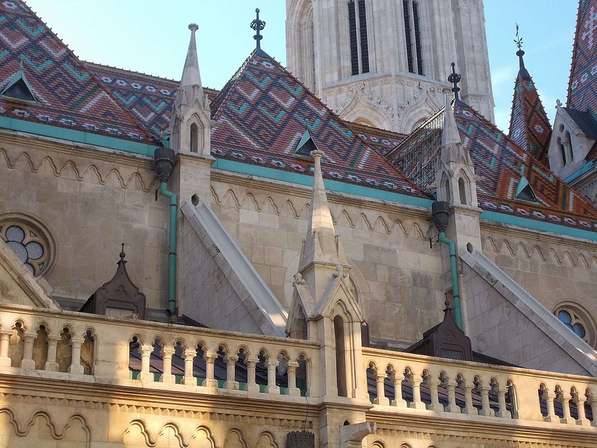 Close view of the glazed Zsolnay tiled roof of Matthias Church in Budapest, patterned in turquoise, ochre, white and brown diamonds