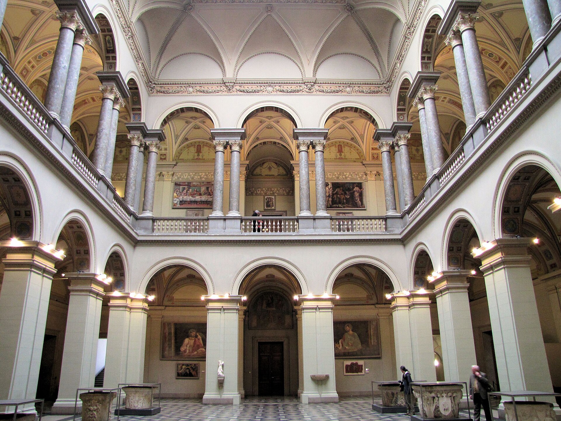 The arcaded Renaissance Hall of the Museum of Fine Arts in Budapest with marble columns and vaulted ceilings