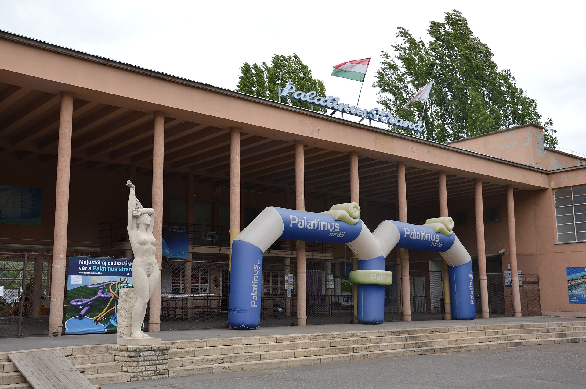 The entrance to the Palatinus Strand, the open-air lido on Margaret Island, with its sign and Hungarian flags