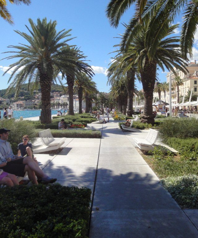 The palm-lined Riva promenade on the waterfront in Split, with the sea on one side and café terraces on the other