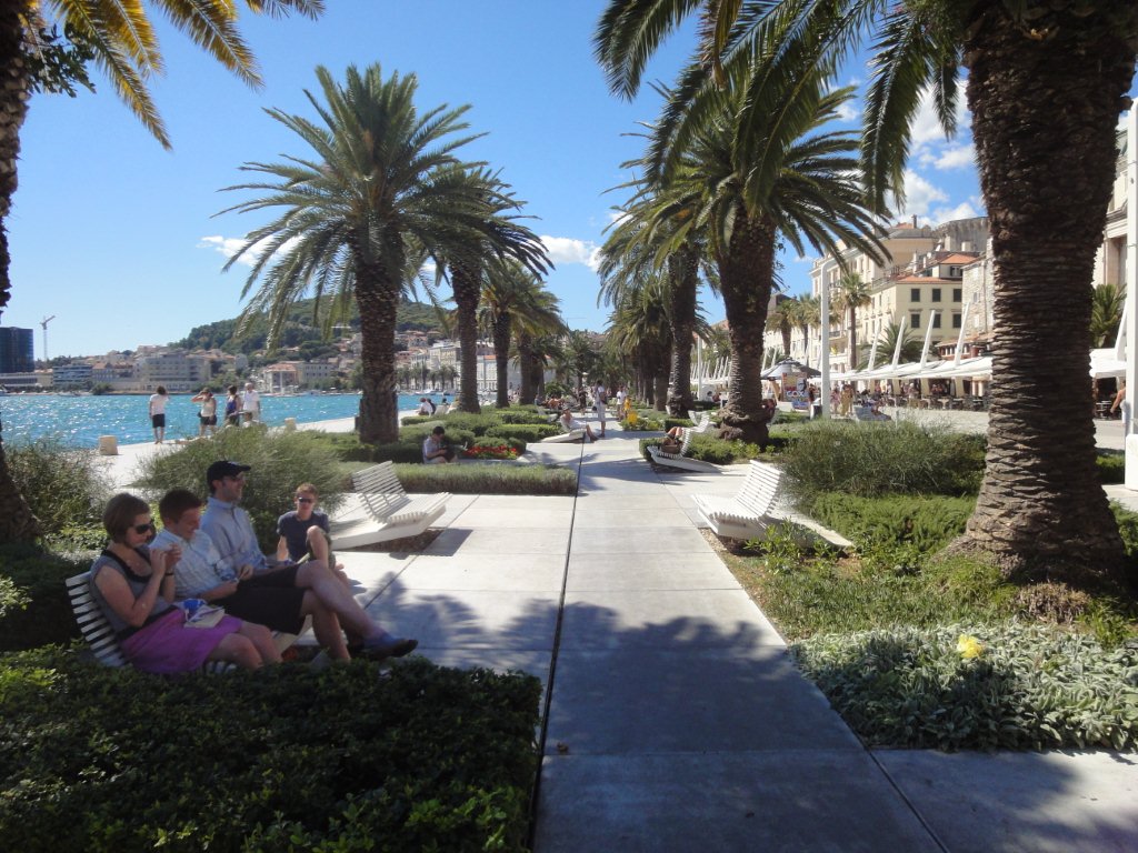 The palm-lined Riva promenade on the waterfront in Split, with the sea on one side and café terraces on the other