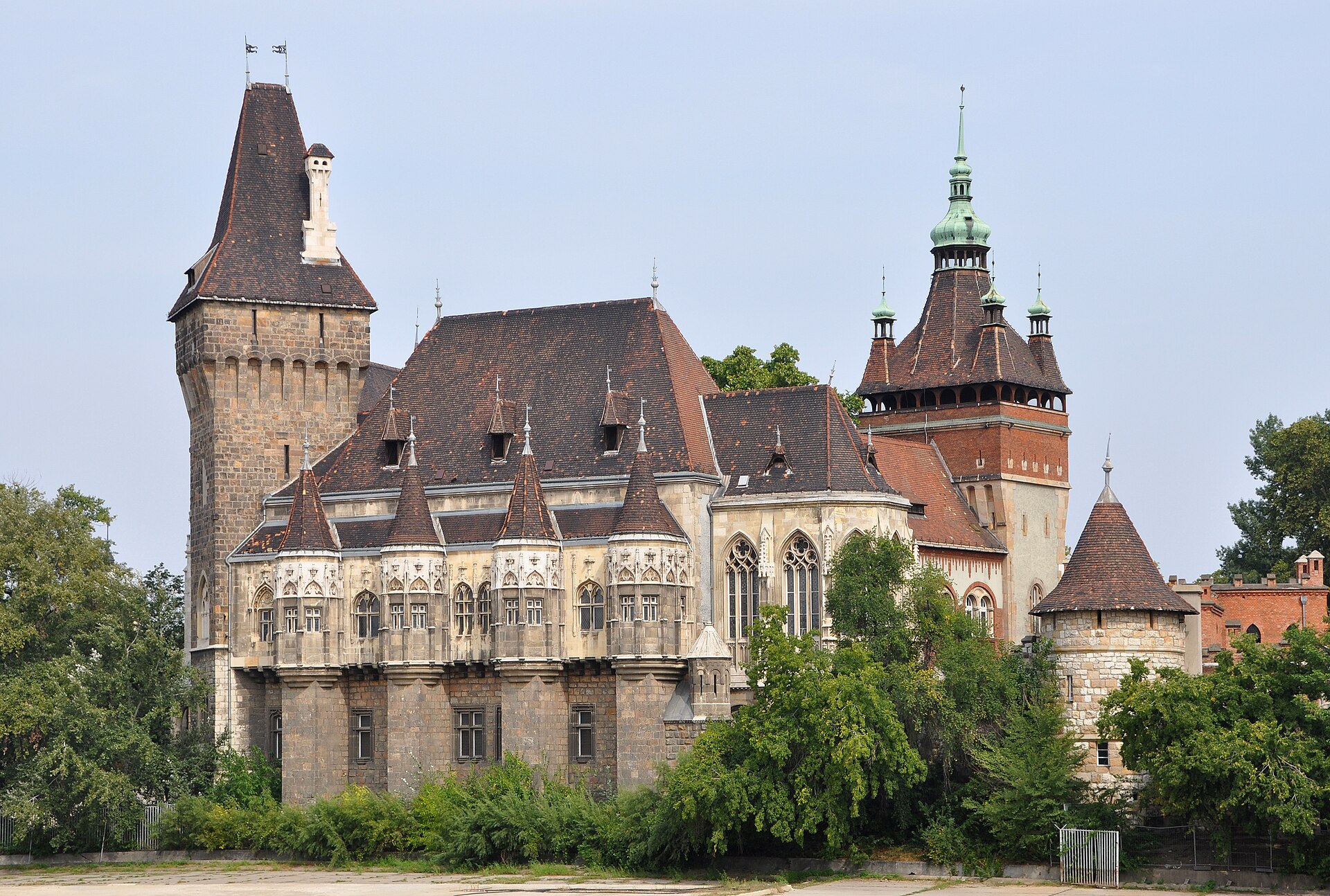 Vajdahunyad Castle in Budapest showing its Gothic wing with oriel windows and the Renaissance-style tower behind