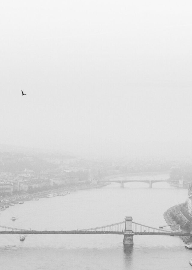 The Danube in thick fog seen from Gellért Hill, with the Chain Bridge in the foreground, the Parliament on the right bank and Margaret Bridge fading into the mist